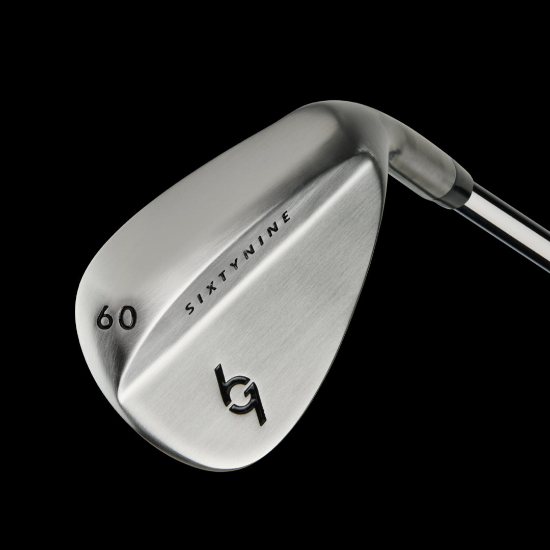 69Golf 60-degree wedge with brushed stainless steel clubhead and gray grip against black background.